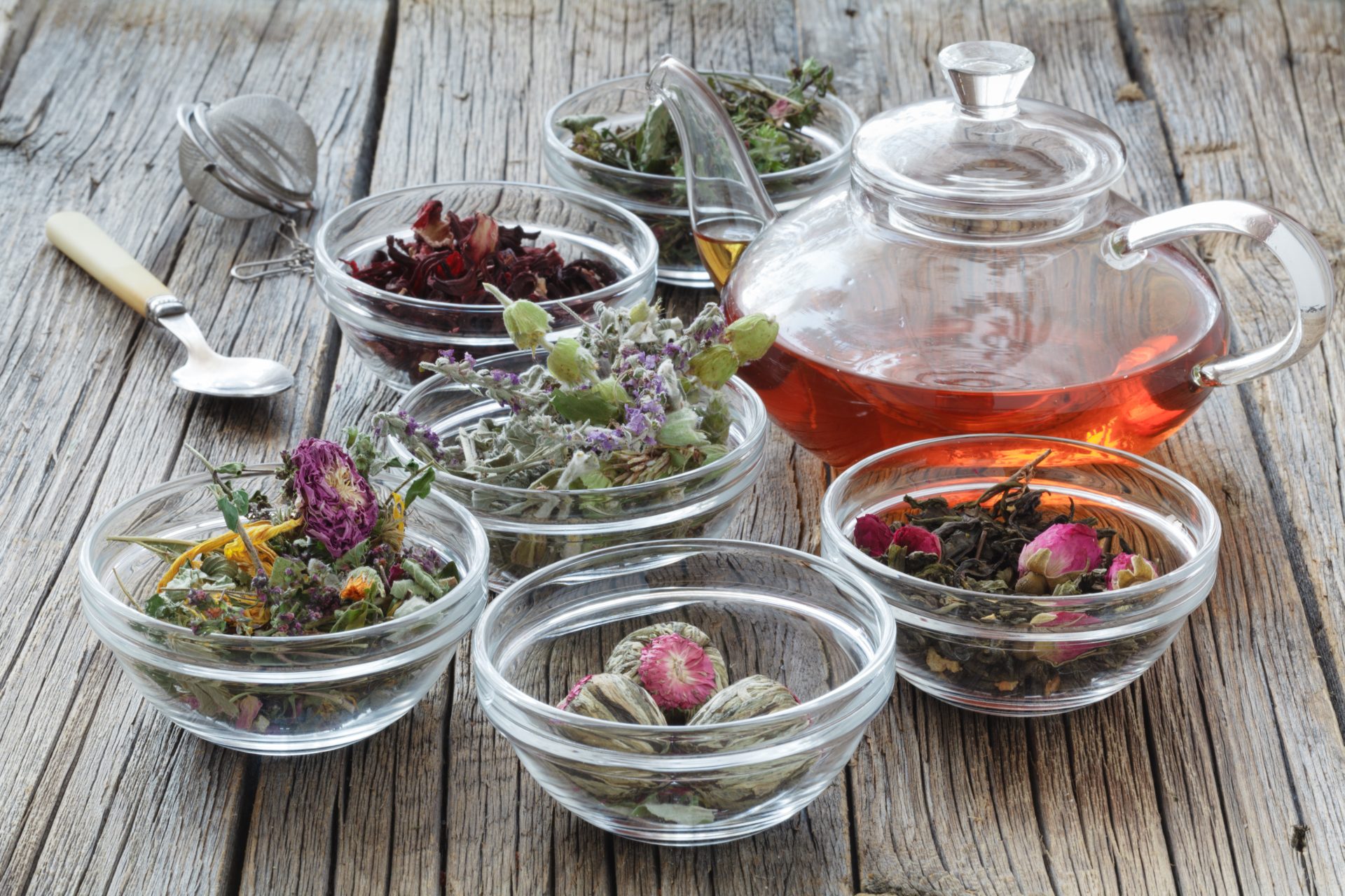 Herbal tea ingredients with glass teapot.
